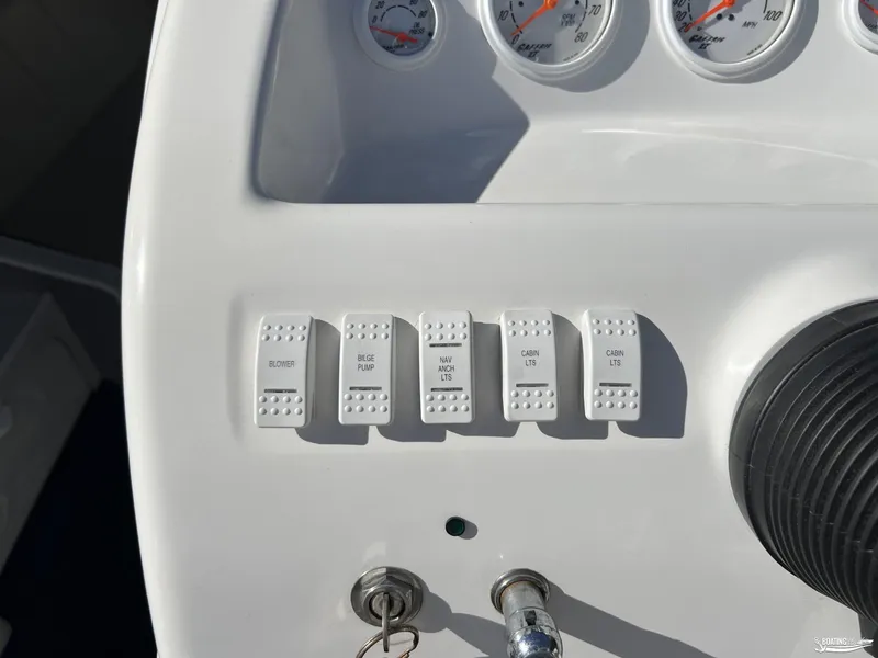 Slide: The Image of Control panel of a 2002 Nordic 28 Heat MCOB boat with labeled switches and gauges. - 8