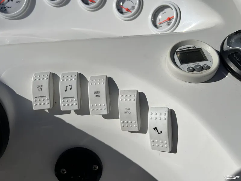 Slide: The Image of Control panel of a 2002 Nordic 28 Heat MCOB boat with labeled switches and gauges. - 9