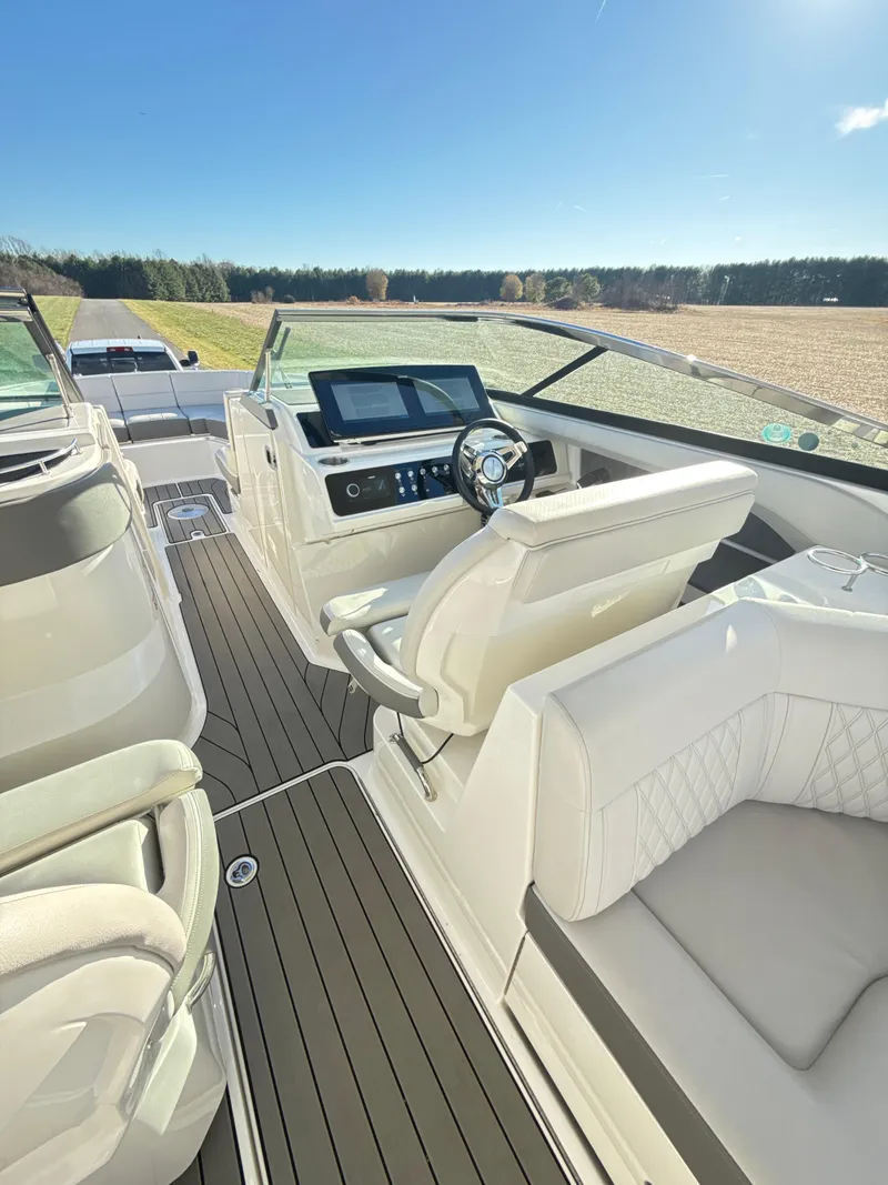 Slide: The Image of 2023 Sea Ray SLX 310 OB boat interior with modern helm and luxurious seating. - 16