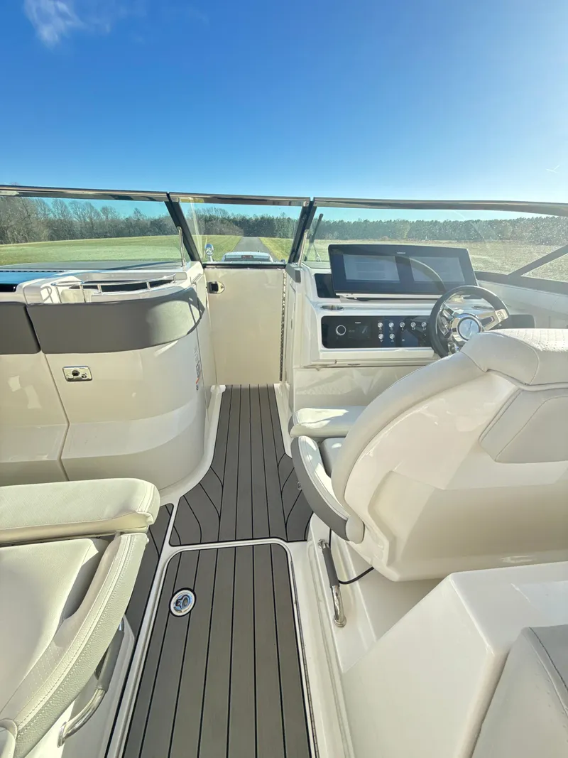 Slide: The Image of 2023 Sea Ray SLX 310 OB boat interior with modern dashboard and seating. - 17