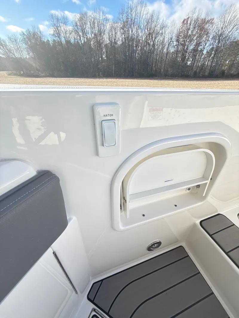 Slide: The Image of 2023 Sea Ray SLX 310 OB boat interior with seating and storage compartment. - 26