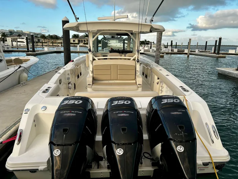 Slide: The Image of 2019 Boston Whaler 380 Outrage with triple 350 engines docked at marina. - 10