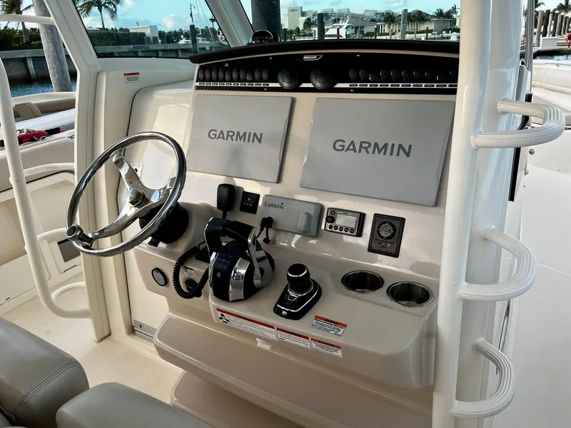 Slide: The Image of 2019 Boston Whaler 380 Outrage helm with dual Garmin displays and modern controls. - 13
