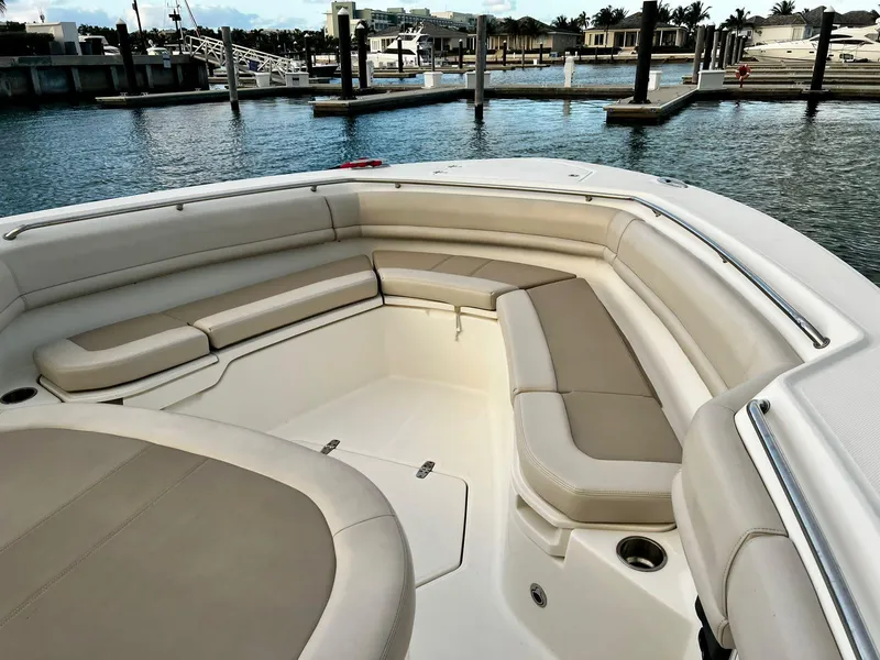 Slide: The Image of 2019 Boston Whaler 380 Outrage boat interior with spacious seating at marina. - 15