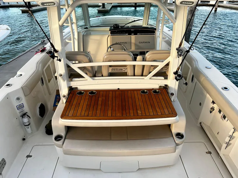 Slide: The Image of 2019 Boston Whaler 380 Outrage boat interior with seating and fishing rod holders. - 17