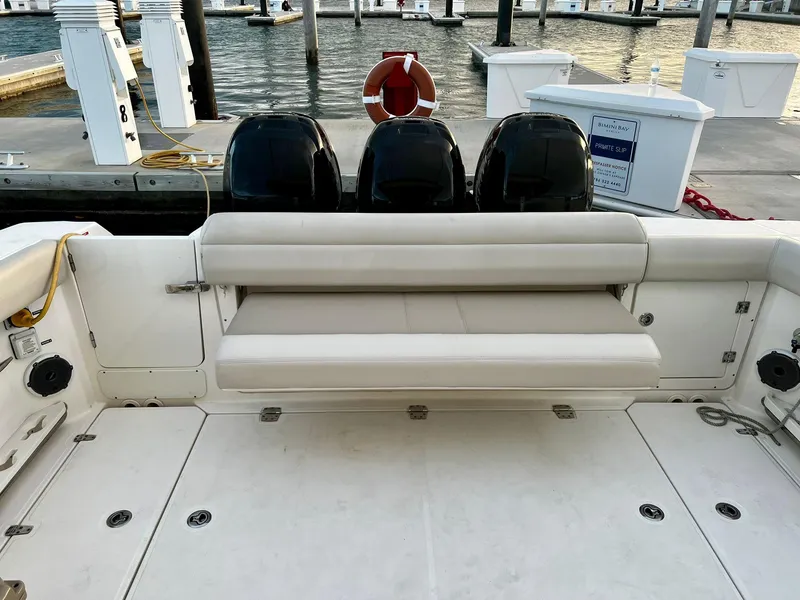 Slide: The Image of Boston Whaler 380 Outrage 2019 boat with seating and triple engines at dock. - 20