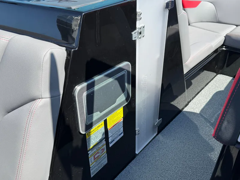 Slide: The Image of 2022 MasterCraft XT24 interior with sleek seating and safety labels. - 18