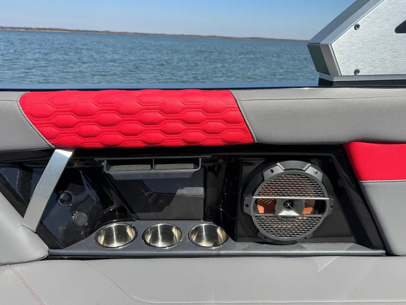 Slide: The Image of Interior of 2022 MasterCraft XT24 boat with red upholstery and speaker system. - 26