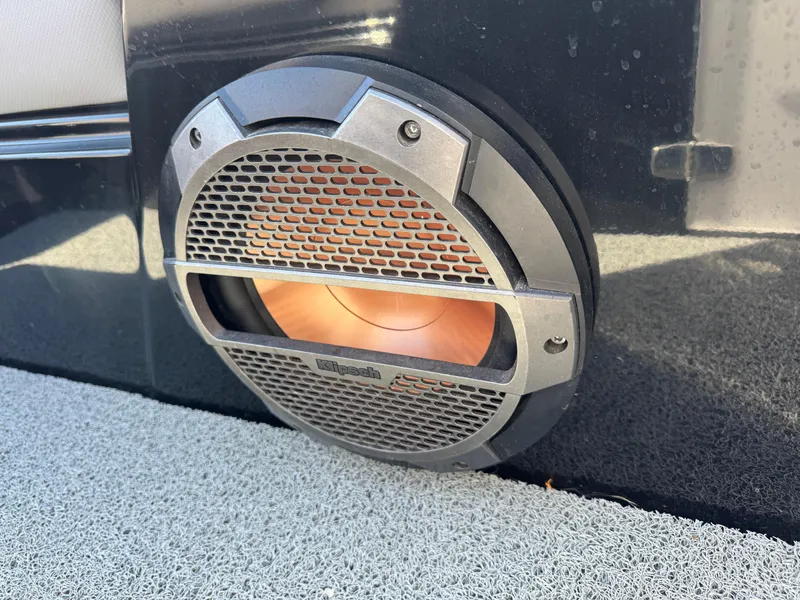 Slide: The Image of Speaker on 2022 MasterCraft XT24 boat, featuring a sleek design and metallic grille. - 31