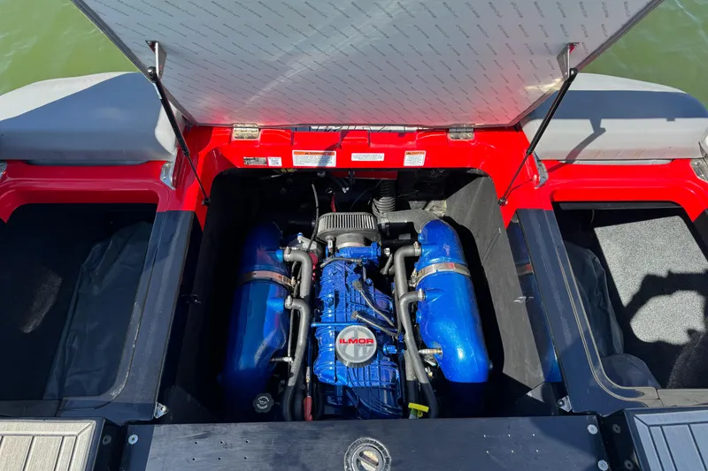 Slide: The Image of 2022 MasterCraft XT24 boat engine compartment with open hatch, showcasing powerful motor. - 33
