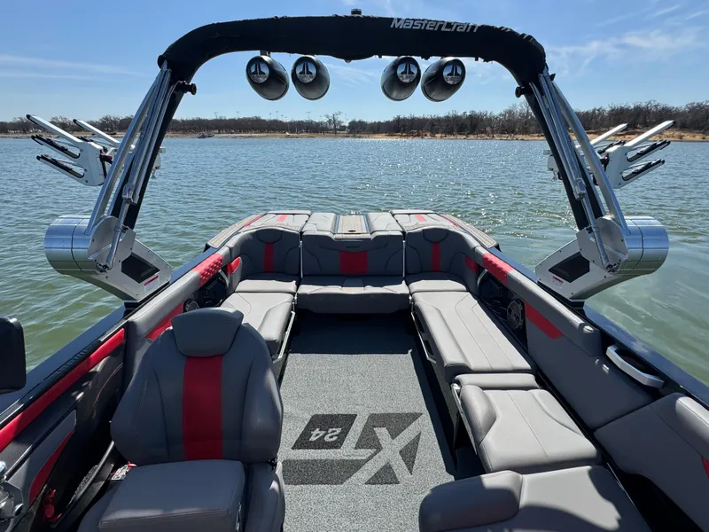 Slide: The Image of 2022 MasterCraft XT24 boat interior with spacious seating on a lake. - 8