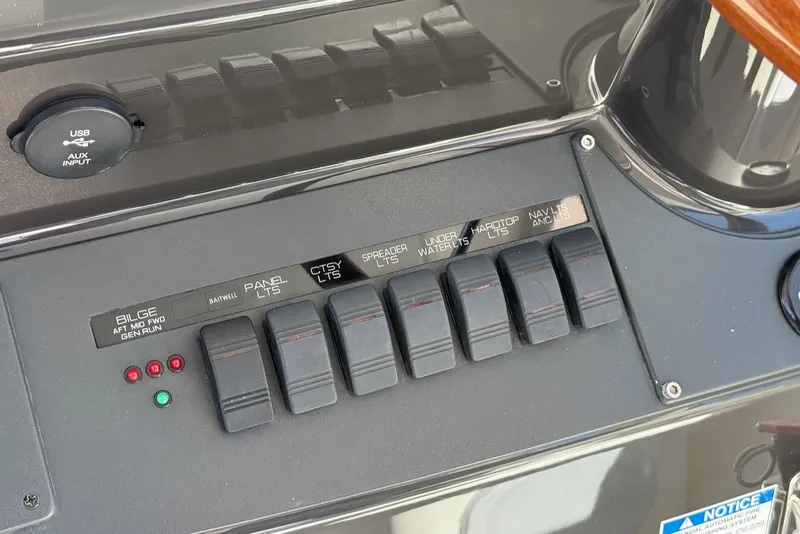 Slide: The Image of Control panel of a 2020 Tiara Yachts 39 Coronet with labeled switches and USB input. - 23