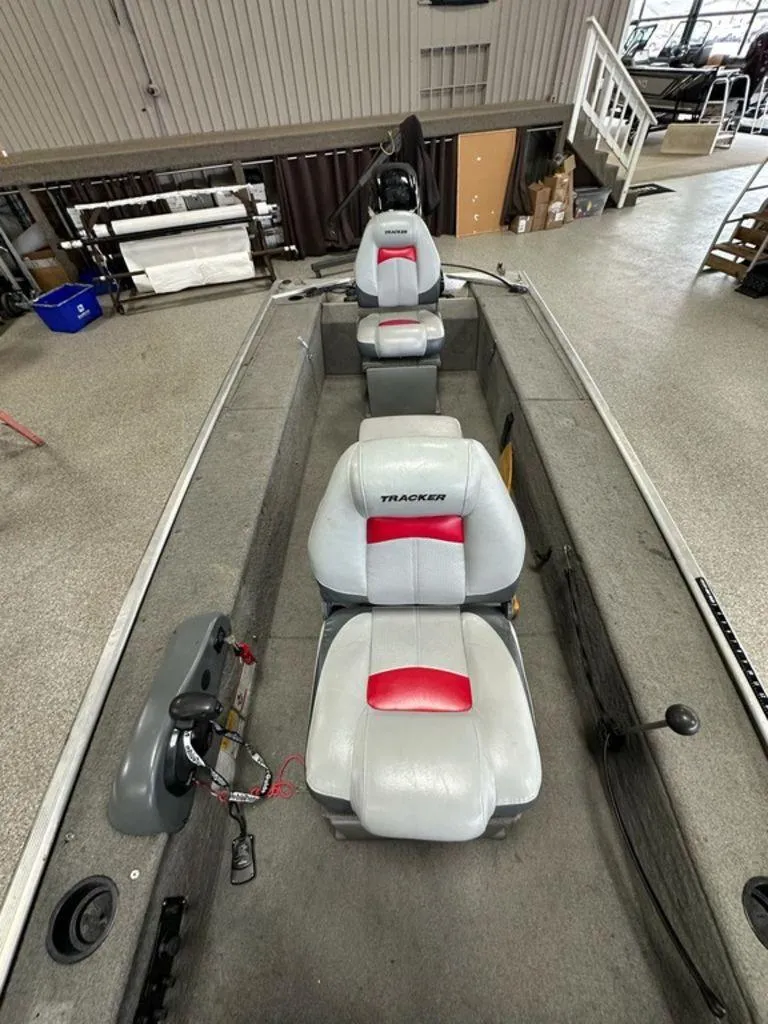 Slide: The Image of 2012 Bass Tracker Panfish 16 boat interior with three seats and steering console. - 6
