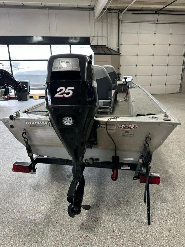 Slide: The Image of 2012 Bass Tracker Panfish 16 boat with 25 HP motor in a garage setting. - 9