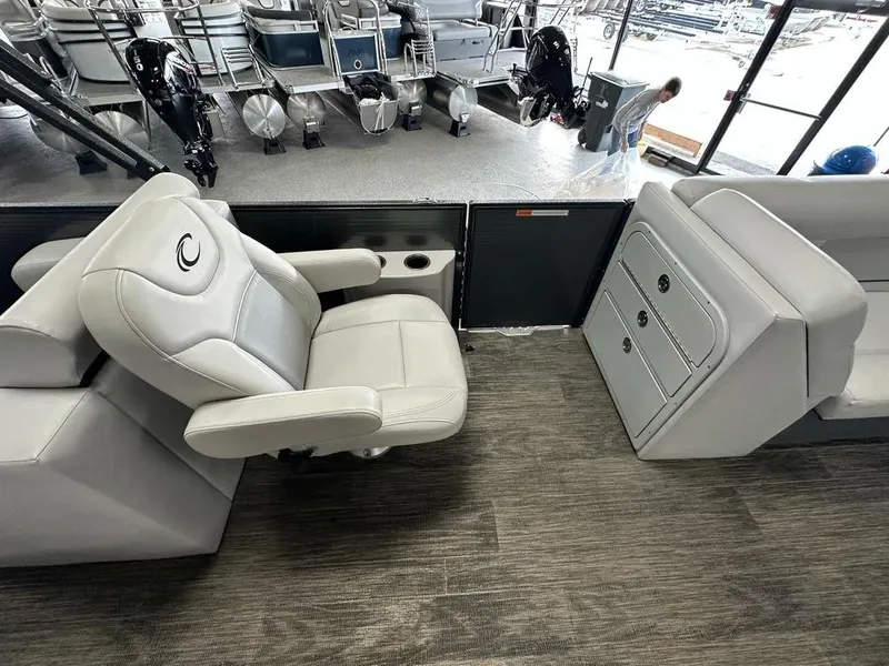 Slide: The Image of 2022 Crest Classic LX 220 SLRC CPT boat interior with plush seating and storage compartments. - 11