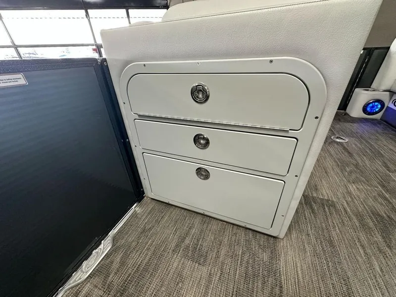 Slide: The Image of 2022 Crest Classic LX 220 SLRC CPT boat interior storage drawers. - 12