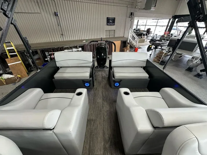 Slide: The Image of 2022 Crest Classic LX 220 SLRC CPT pontoon boat interior with gray seating in showroom. - 13