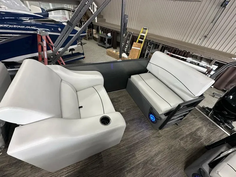 Slide: The Image of 2022 Crest Classic LX 220 SLRC CPT boat interior with gray seating and cup holder. - 14