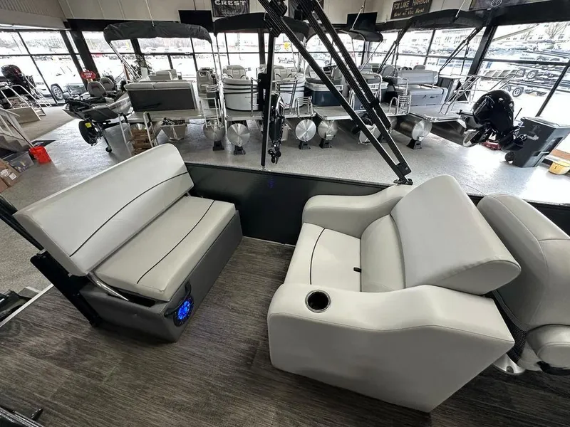 Slide: The Image of Interior of 2022 Crest Classic LX 220 SLRC CPT pontoon boat with gray seating. - 16