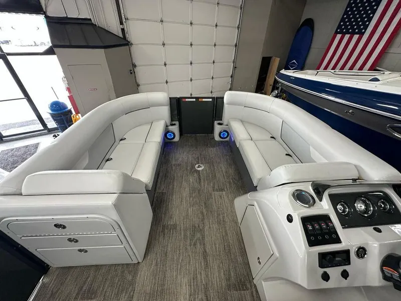 Slide: The Image of Interior of 2022 Crest Classic LX 220 SLRC CPT pontoon boat with plush seating and control panel. - 3