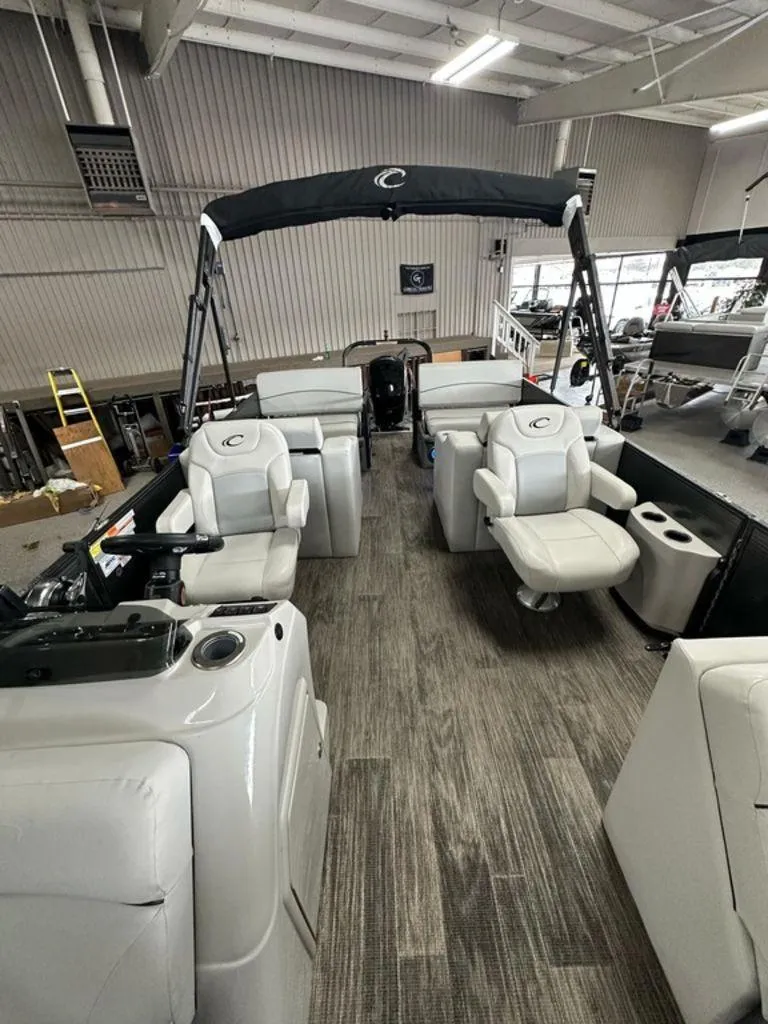 Slide: The Image of 2022 Crest Classic LX 220 SLRC CPT pontoon boat interior with seating and canopy. - 6