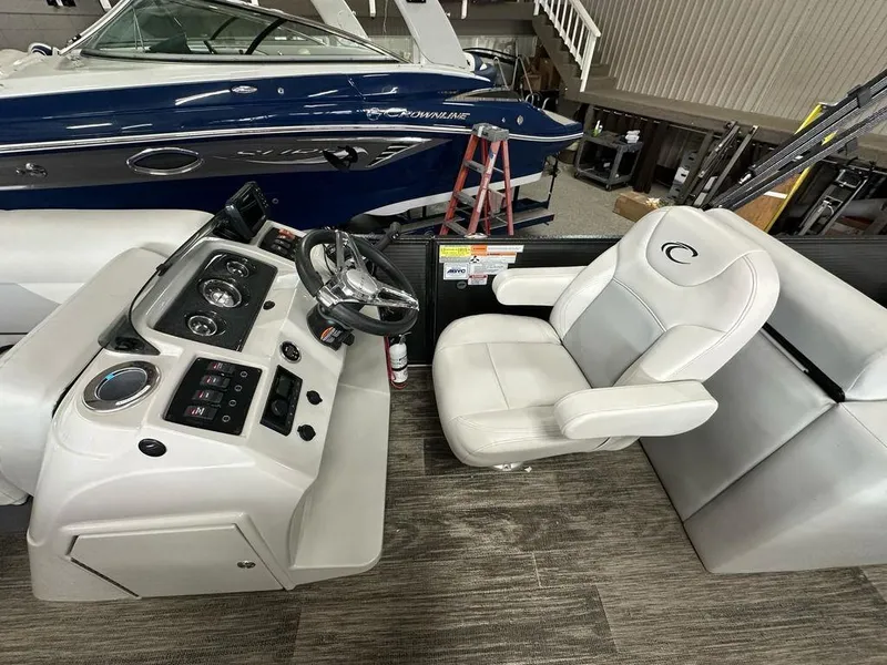 Slide: The Image of 2022 Crest Classic LX 220 SLRC CPT boat interior with steering console and captain's chair. - 7