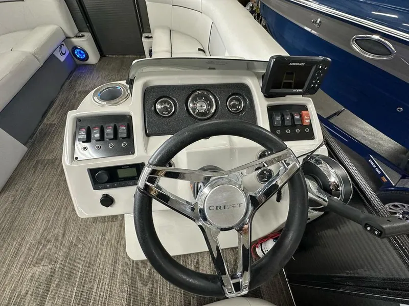 Slide: The Image of 2022 Crest Classic LX 220 SLRC CPT boat dashboard with steering wheel and control panel. - 8