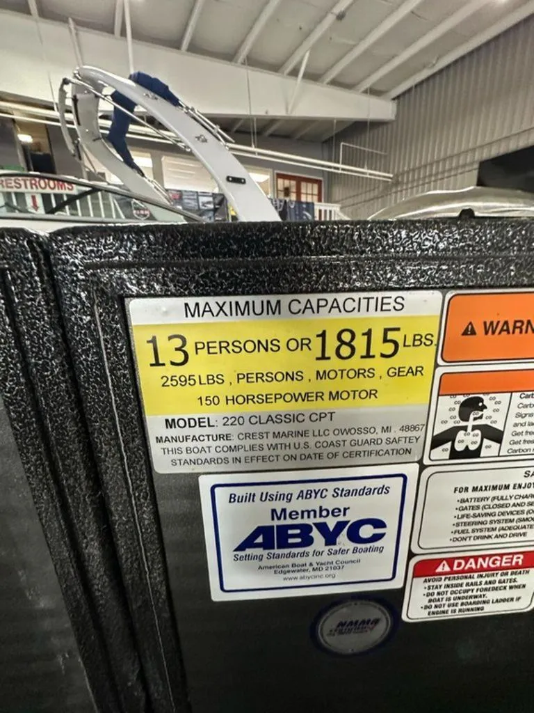 Slide: The Image of 2022 Crest Classic LX 220 SLRC CPT capacity label, 13 persons or 1815 lbs, 150 horsepower motor. - 9