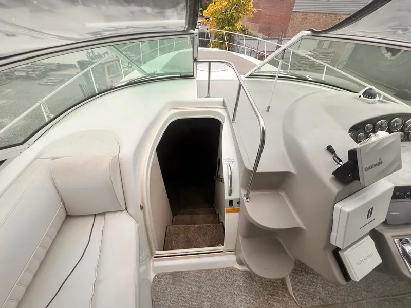 Slide: The Image of 2001 Cruisers Yachts 3870 Express cockpit with stairs to cabin, featuring modern controls. - 11