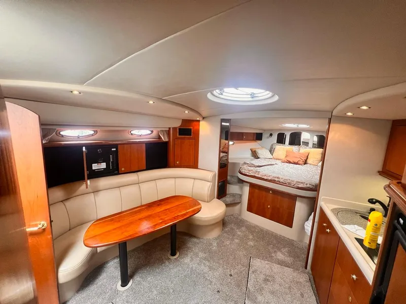 Slide: The Image of 2001 Cruisers Yachts 3870 Express interior with seating, table, and bed. - 15