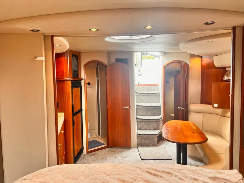 Slide: The Image of 2001 Cruisers Yachts 3870 Express interior with wood accents and cozy seating area. - 19