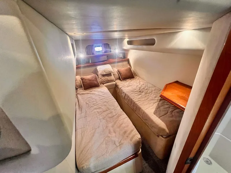 Slide: The Image of 2001 Cruisers Yachts 3870 Express cabin with twin beds and cozy interior. - 23