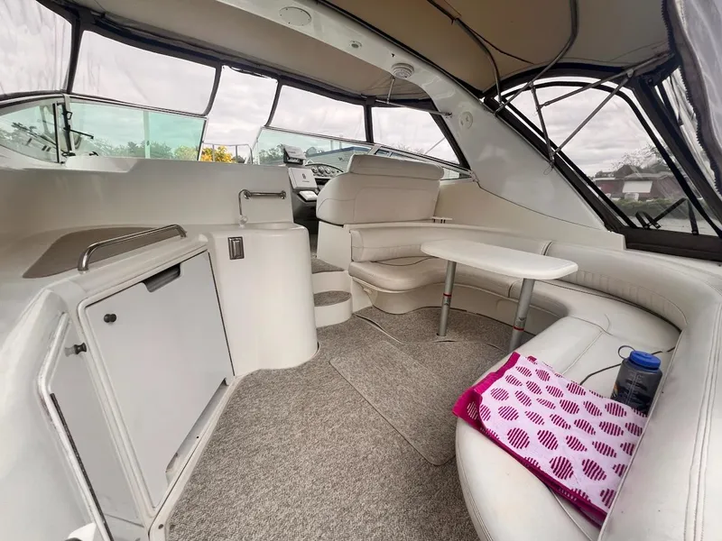 Slide: The Image of 2001 Cruisers Yachts 3870 Express interior with seating, table, and helm. - 4