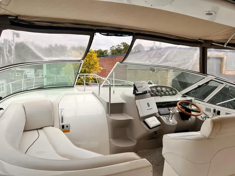Slide: The Image of 2001 Cruisers Yachts 3870 Express helm with leather seating and modern controls. - 6