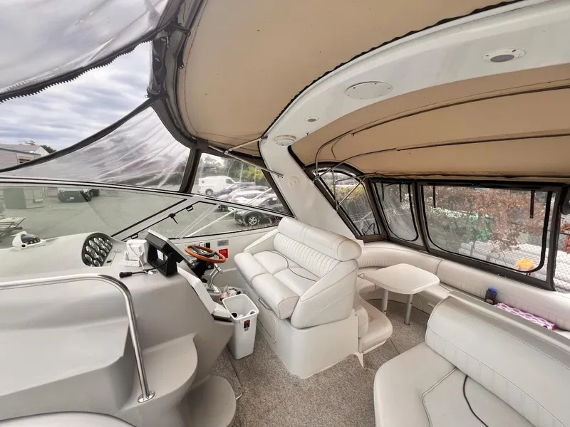 Slide: The Image of 2001 Cruisers Yachts 3870 Express interior with white seating and helm. - 7