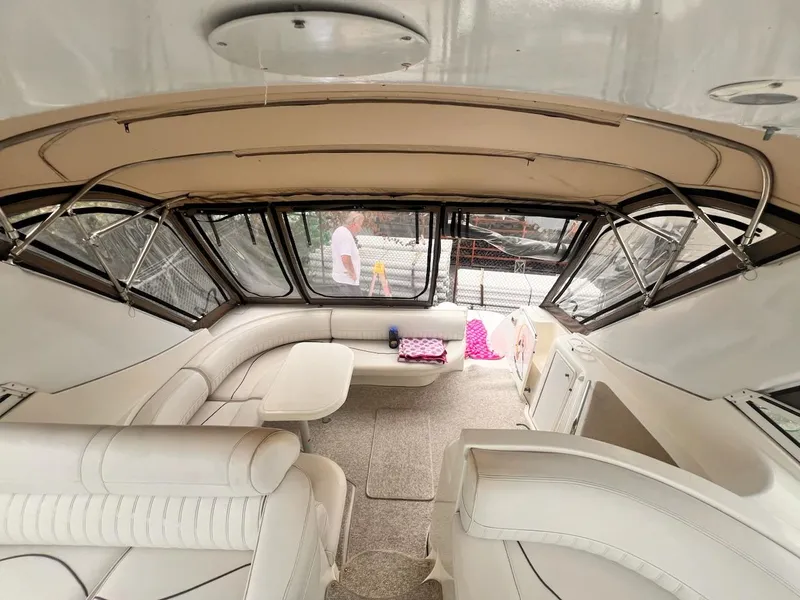 Slide: The Image of 2001 Cruisers Yachts 3870 Express interior with white seating and panoramic windows. - 10