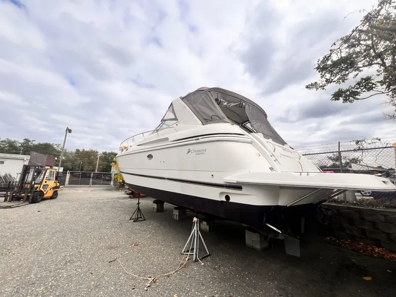 Slide: The Image of 2001 Cruisers Yachts 3870 Express on dry dock, overcast sky background. - 2