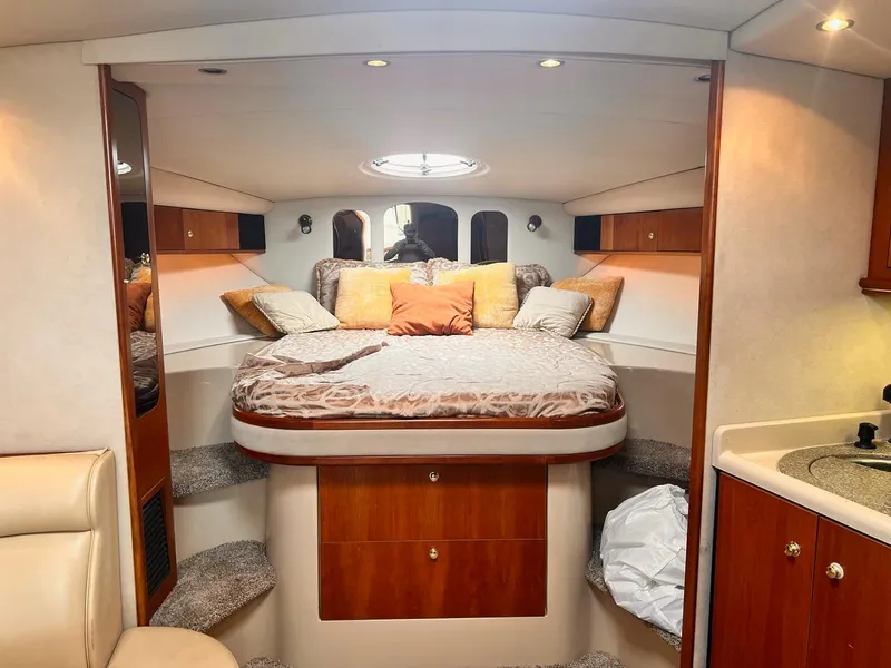 Slide: The Image of Luxurious 2001 Cruisers Yachts 3870 Express cabin interior with cozy bed and elegant wood finish. - 20