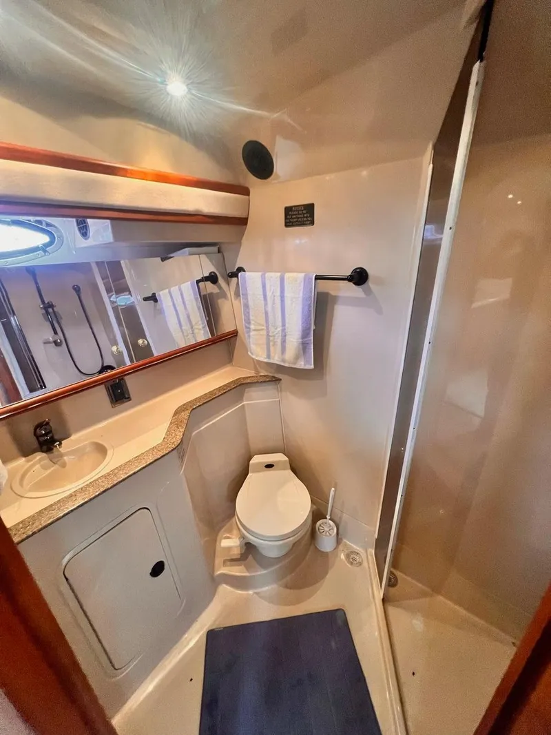 Slide: The Image of 2001 Cruisers Yachts 3870 Express bathroom with shower, sink, and toilet. - 21