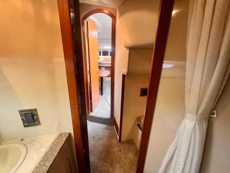 Slide: The Image of Interior of 2001 Cruisers Yachts 3870 Express, featuring hallway and cabin view. - 22