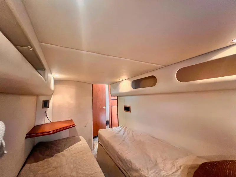 Slide: The Image of Interior cabin of 2001 Cruisers Yachts 3870 Express with twin beds and wooden accents. - 24