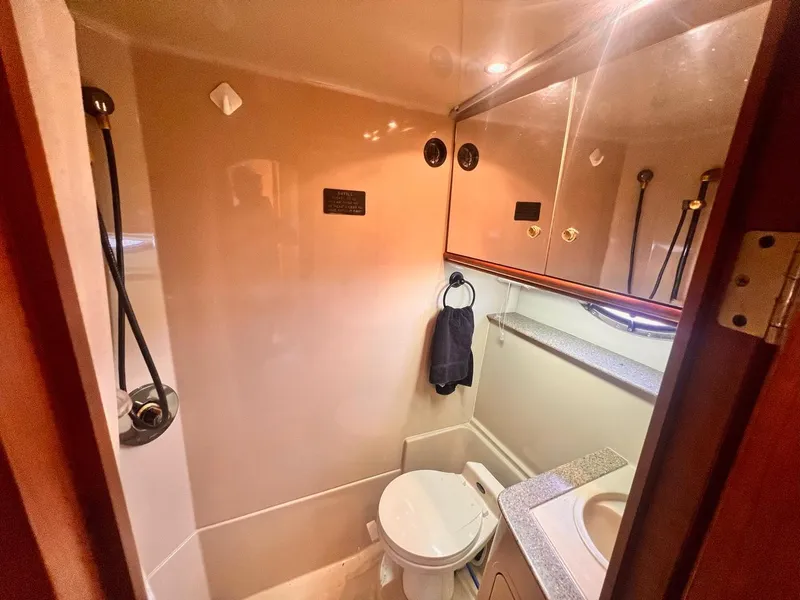 Slide: The Image of Bathroom interior of 2001 Cruisers Yachts 3870 Express, featuring toilet and sink. - 25