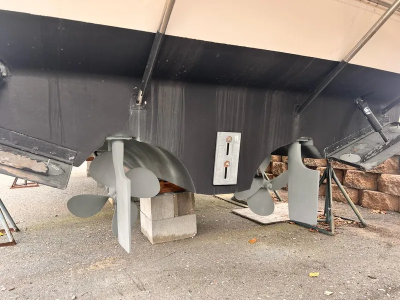 Slide: The Image of 2001 Cruisers Yachts 3870 Express boat hull and propellers on dry dock. - 26