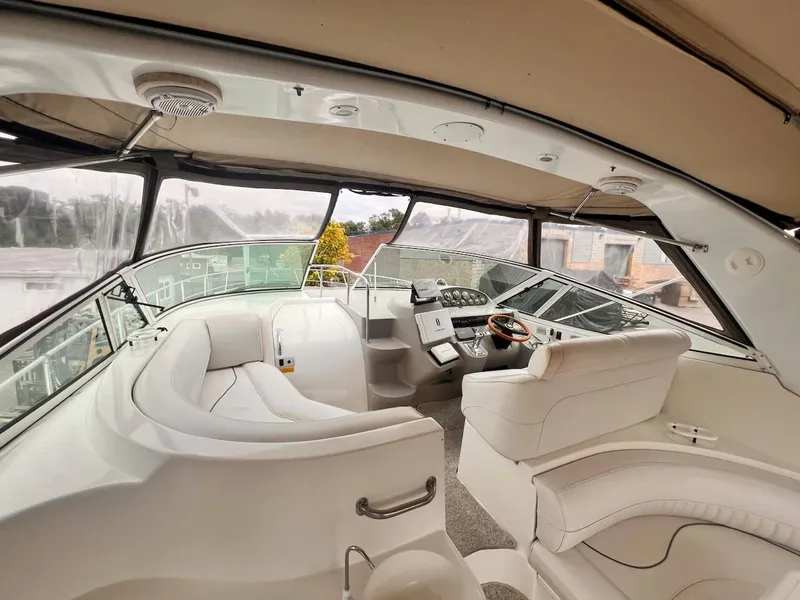 Slide: The Image of 2001 Cruisers Yachts 3870 Express cockpit with white seating and modern controls. - 5
