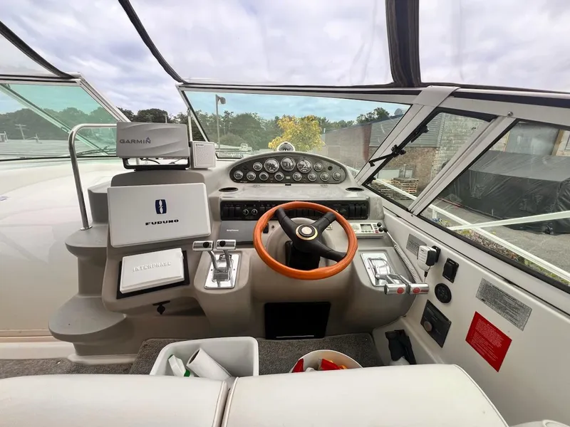 Slide: The Image of 2001 Cruisers Yachts 3870 Express helm with steering wheel and navigation equipment. - 8