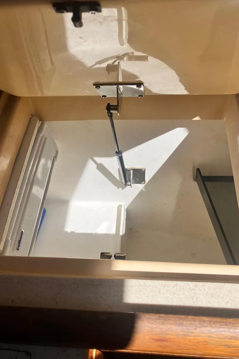 Slide: The Image of Open storage compartment in 2003 Hunter 326 boat interior. - 17