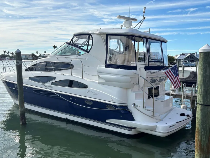 Slide: The Image of 2006 Cruisers Yachts 415 Express Motoryacht docked in a marina. - 1