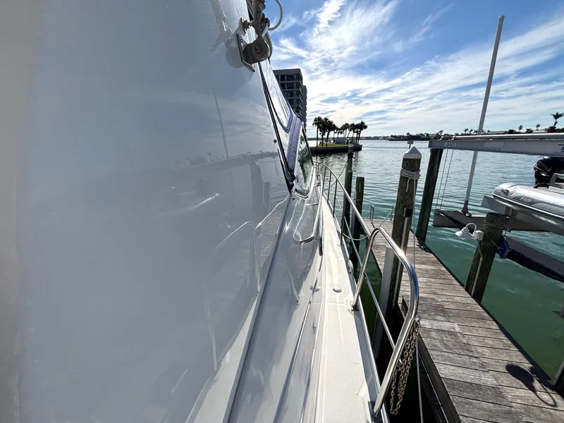 Slide: The Image of 2006 Cruisers Yachts 415 Express Motoryacht docked by a sunny marina. - 10
