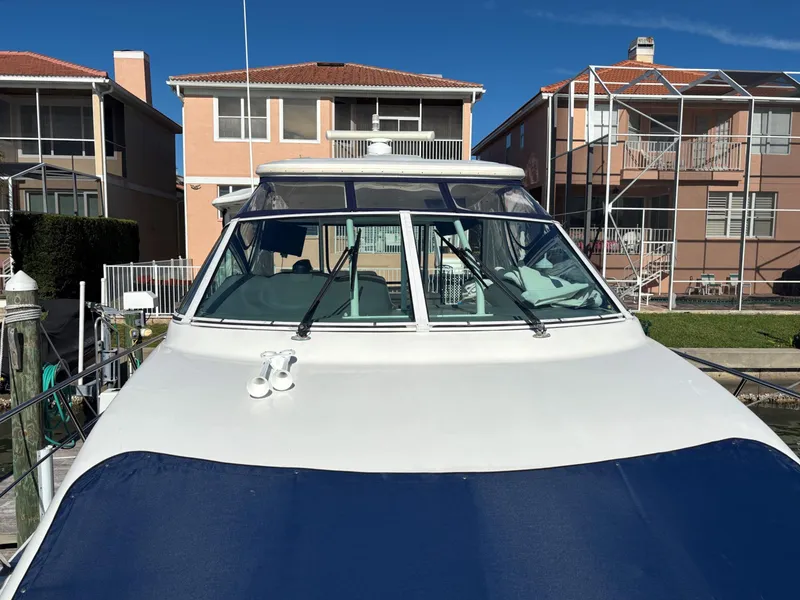 Slide: The Image of 2006 Cruisers Yachts 415 Express Motoryacht docked near waterfront homes. - 12