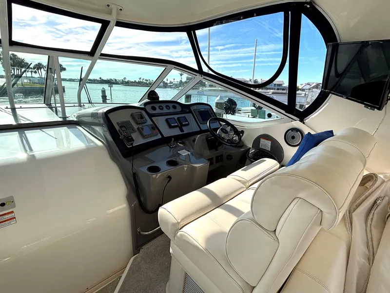 Slide: The Image of 2006 Cruisers Yachts 415 Express Motoryacht helm with leather seating and panoramic windows. - 18